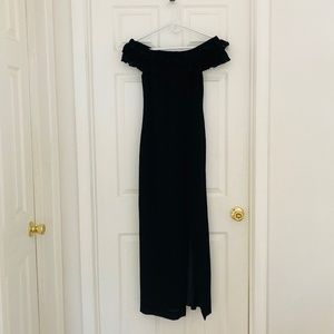 Fitted black dress with ruffled off the shoulder sleeves